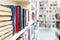 Library with bookcases. Many different books on the shelves. Large selection of books in a bookcase. Blur background.