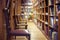 Library with books on shelf and empty chairs