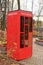 A library in a children amusement park in the form of a red telephone booth, an inscription in Cyrillic, a library