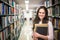 In the library - pretty female student with books working in a h