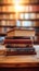 Library serenity Books stacked on wooden table, blurred bookshelf backdrop