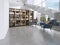 Library shelves with books in the contemporary room and large windows, under the stairs