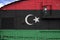 Libya flag depicted on side part of military armored tank closeup. Army forces conceptual background