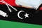 Libya flag depicted on table with internet rj45 cable, wireless usb wifi adapter and router. Internet connection concept