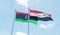 Libya and Iraq, two flags waving against blue sky