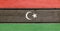 Libyan Arab Jamahiriya flag painted on wood plank background