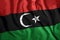 The Libyan flag flies in the wind. Colorful national flag of Libya. Patriotism, patriotic symbol