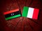 Libyan flag with Italian flag on a tree stump isolated