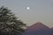 Licancabur Volcano and full moon at dusk in Chile`s Atacama Desert