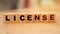 License, text written on wooden block, business term