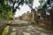 Lichen-covered ancient stone path and parapet in warm afternoon