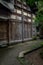 Lichen-covered path before aged Chinese timber structural house