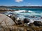 Lichen red rocks on the coastline at Binalong Bay harbour Tasmania Australia