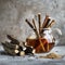 Licorice tea in glass teapot, aromatic licorice root dried sticks and powder on light table