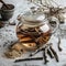 Licorice tea in glass teapot, aromatic licorice root dried sticks and powder on light table