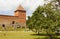 Lida, Belarus - July 11, 2016: Stone building takes the form of misuse of the quadrilateral with two corner towers. In front there