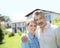 Liddle-aged couple standing on front of the house