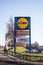 Lidl, Pound Stretcher and The Pet Hut shop signs in outdoor urban setting with car park in the background