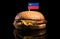 Liechtenstein flag on top of hamburger isolated on black