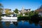 Liedekerke, East Flemish Region, Belgium - Ship, houses and trees reflecting in the river Dender