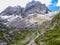 Lienz Dolomites - Barren slopes of tall mountain range with the lake in the valley