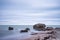 Liepaja beach bunker. Brick house, soft water, waves and rocks. Abandoned military ruins facilities in a stormy sea.