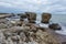 Liepaja beach bunker. Brick house, soft water, waves and rocks. Abandoned military ruins facilities in a stormy sea.