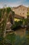 Lierganes, Cantabria, Spain. 05-25-2019. Roman bridge and Monument to the Man Fish. Monumento al hombre Pez. River Miera.  Mytholo