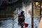 Life along the canal and boatman rowing the Thai traditional small rowboat on the canal