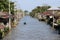 Life along the canal and long tail boat driving the on the Damnoensaduak canal