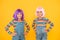 Life is better with friends. Happy girls friends on yellow background. Little friends smile in fashionable hair wigs and