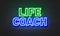 Life coach neon sign on brick wall background.