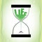 Life concept with hourglass and decreasing sand on the textured green background