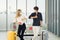 Life during covid-19 pandemic. young man and woman waiting for flying at airport at window with a passport