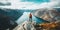 Life on the edge Traveler on cliff mountains over fjord enjoying Norway landscape Travel Lifestyle success motivation concept