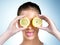 When life gives you lemons, pucker up. Shot of a health-conscious young woman posing with lemons over her eyes in studio