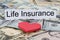 Life insurance text on piece of paper