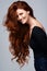 Life isnt perfect but at least my hair is. Studio shot of a young woman with beautiful red hair posing against a gray