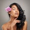 Life isnt perfect, but your hair can be. a beautiful young woman posing with a flower in her hair.