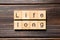 Life long word written on wood block. life long text on table, concept