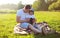 Life portrait of father and son sitting together on the grass