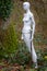 Life size naked female white mannequin with fork in woodland setting at Marston Park, Somerset, UK