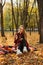 Life Style Portrait of Happy Woman in fall park. Beautiful girl on the nature picnic camping. Relaxing Girl in autumn Nature.