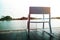 Life Unpluged Concept. Relaxing by the River. Empty Armchair on Wooden Patio Deck. Holidays Leisure and Relaxing Lifestyle.