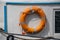 Lifebelt with lifeline on a white background on a ship