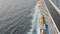 Lifeboat on giant cruise ship view down to ocean surface with waves below while ship cruising saling in the sea. Safty muster