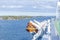 Lifeboats, decks and cabins on the side of cruise ship. Wing of running bridge of cruise liner. White cruise ship on a blue sky