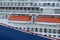 Lifeboats hanging over deck on cruise ship