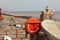 A lifebouy at the eastern end of Sidmouth Esplanade looking over the River Sid and on towards the East beach