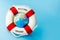 Lifebuoy and globe on blue background. Summer or vacation concept. Copy space